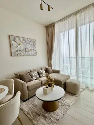 a living room with a couch and a table at Chic Urban 1br In Jvc With Modern Amenities in Dubai