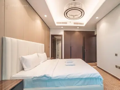 a bedroom with a large bed with white sheets at Stunning One Bed Apartment In Luxury Tower in Dubai