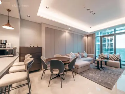 a living room with a table and chairs at Stunning One Bed Apartment In Luxury Tower in Dubai