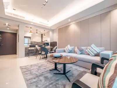a living room with a couch and a table at Stunning One Bed Apartment In Luxury Tower in Dubai