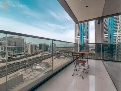a balcony with a table and a view of a city at Stunning One Bed Apartment In Luxury Tower in Dubai