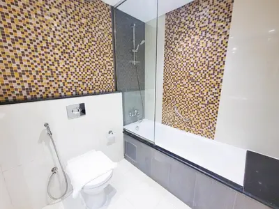 a bathroom with a toilet and a shower at Damac Upper Crest - Blue Ocean Holiday Homes in Dubai