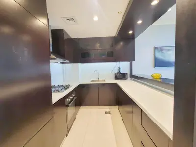 a kitchen with a sink and a counter top at Damac Upper Crest - Blue Ocean Holiday Homes in Dubai