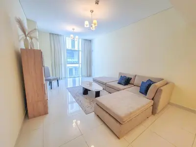 a living room with a couch and a table at Damac Park Central - Blue Ocean Holiday Homes in Dubai
