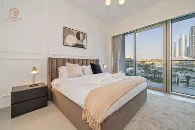 a bedroom with a large bed and a large window at Burj Khalifa Views 2-Bedroom Apartment 203GR-2 in Dubai