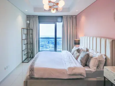 a bedroom with a large bed with a large window at High Floor , Premium 1 Bedroom , Stunning Views in Dubai