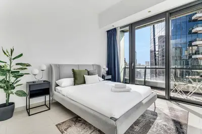 a bedroom with a bed and a large window at GuestReady - Dubai Marina retreat with balcony in Dubai