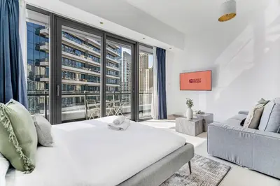 a bedroom with a white bed and a large window at GuestReady - Dubai Marina retreat with balcony in Dubai