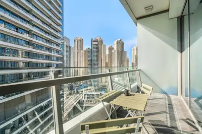 a balcony with a bench and a view of a city at GuestReady - Dubai Marina retreat with balcony in Dubai