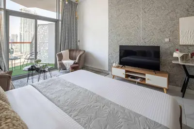 a bedroom with a bed and a flat screen tv at Frank Porter - Millennium Binghatti Residences in Dubai