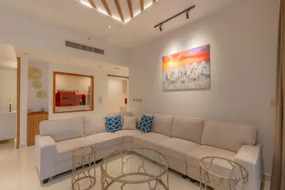 a living room with a couch and two tables at Luxury 3BR Stunning Burj Khalifa View in Dubai