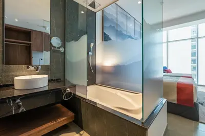 a bathroom with a sink and a glass shower at Grand Millennium Business Bay in Dubai