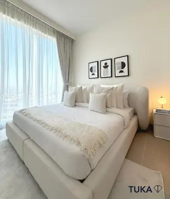 a large white bed in a room with a large window at 2BR Forte Tower 1 Downtown 3mn Burj Khalifa in Dubai