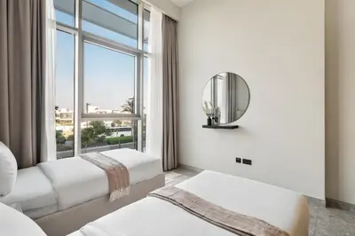 a hotel room with three beds and a window at Luxury 2 Bedroom in Golf Suites Dubai Hills in Dubai
