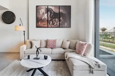 a living room with a couch and a table at Luxury 2 Bedroom in Golf Suites Dubai Hills in Dubai