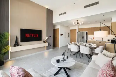 a living room with a couch and a dining room at Luxury 2 Bedroom in Golf Suites Dubai Hills in Dubai
