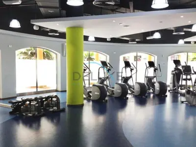 a gym with several treadmills and elliptical machines at Lovely Studio in Murjan 2, Jumeirah Beach Residence by Deluxe Holiday Homes in Dubai