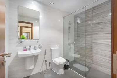 a bathroom with a toilet and a sink and a shower at Heaven Crest Vacation Homes Downtown - 3 Bedroom Suites 2 minute walk to Dubai Mall and Burj Khalifa in Dubai