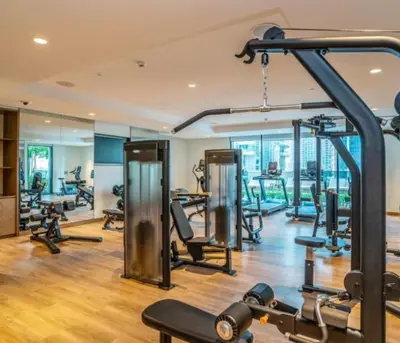 a gym with several treadmills and exercise machines at Luxury Apartment ACT One Act Two 7 Min Walk to Burj Khalifa & Dubai Mall in Dubai