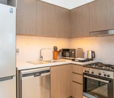 a kitchen with a sink and a stove at Luxury Apartment ACT One Act Two 7 Min Walk to Burj Khalifa & Dubai Mall in Dubai
