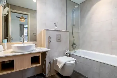 a bathroom with a sink and a toilet and a tub at Downtown Skyline & Burj Khalifa Views Dubai in Dubai
