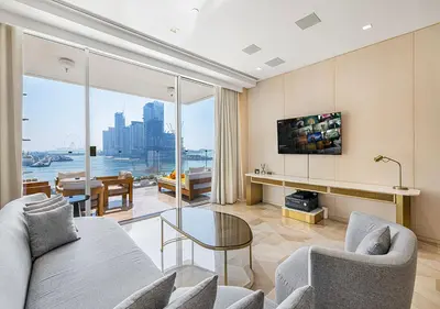 a living room with a couch and a glass table at Daniels Sea View 2BR at Five Palm Jumeirah in Dubai