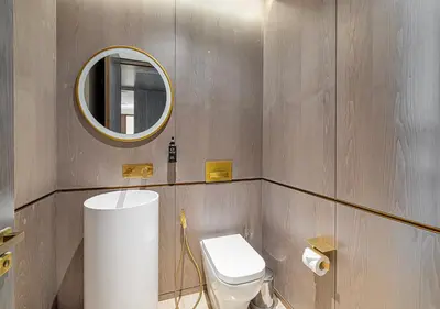 a bathroom with a toilet and a mirror at Daniels Sea View 2BR at Five Palm Jumeirah in Dubai