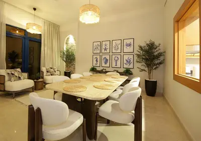 a dining room with a table and white chairs at Luxury Villa With breathtaking View And Beach Access in Dubai