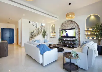 a living room with white furniture and a stone fireplace at Luxury Villa With breathtaking View And Beach Access in Dubai