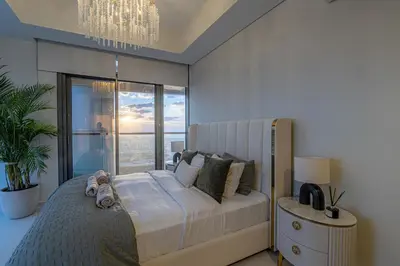 a bedroom with a large bed with a large window at Stunning 3BR w Panoramic Views in Aykon City in Dubai