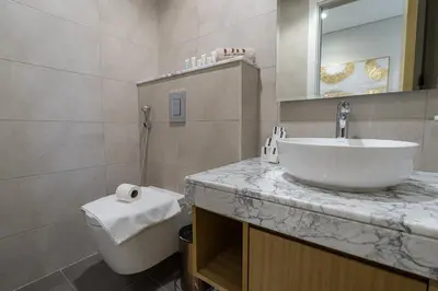 a bathroom with a sink and a toilet at Stunning 3BR w Panoramic Views in Aykon City in Dubai