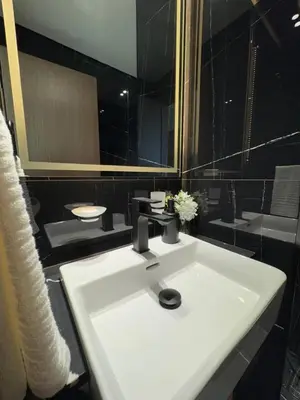 a bathroom with a white sink and a mirror at Trendy & Elegant 1br In Jvc in Dubai
