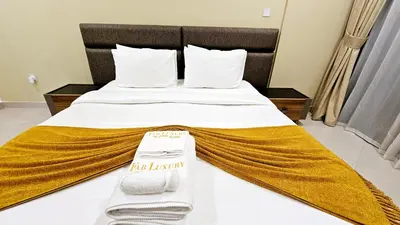 a hotel room with a bed with towels on it at Elegant 2-Bedroom Apartment with Private Balconies & En-Suite Luxury in Meydan Avenue in Dubai