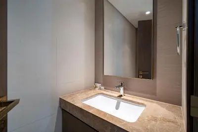 a bathroom with a sink and a mirror at Homes Beyond l 2BR Panoramic Skyline & Sea View in Dubai