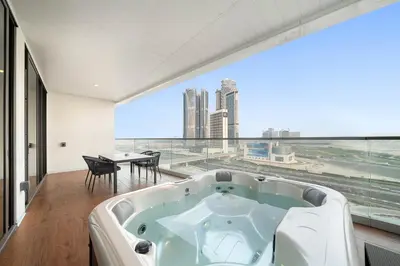 a bath tub in a room with a large window at Business Bay 1BR Canal Views, Pool, Gym & Near Burj Khalifa in Dubai