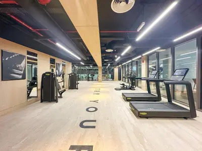 a gym with treadmills and ellipticals in a room at Business Bay 1BR Canal Views, Pool, Gym & Near Burj Khalifa in Dubai