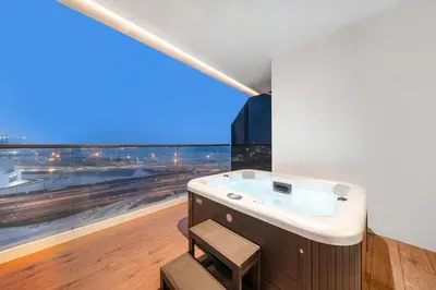 a bathroom with a sink and a large window at Business Bay 1BR Canal Views, Pool, Gym & Near Burj Khalifa in Dubai