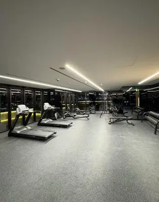 a gym with several treadmills and exercise bikes at Mahogany 2 - 2BR 6PAX - Infinity Pool & Near Metro in Dubai