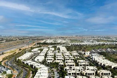 an aerial view of a city with white apartments at Modern 1-BR Golf Course View in Golf Vita in Dubai