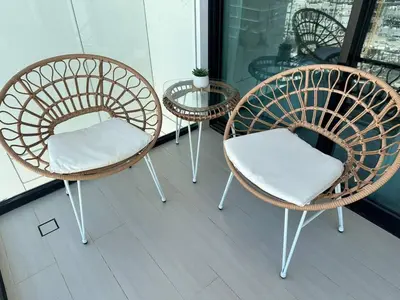 a group of chairs and a table on a balcony at Chic & Modern 1br Apt Balcony Pool Parking in Dubai