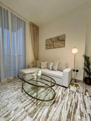 a living room with a couch and a glass table at Chic & Modern 1br Apt Balcony Pool Parking in Dubai