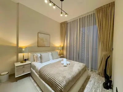 a bedroom with a bed and a large window at Chic & Modern 1br Apt Balcony Pool Parking in Dubai