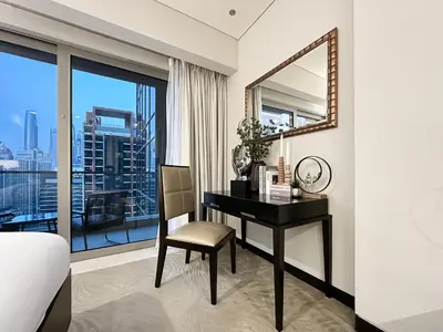 a bedroom with a desk and a mirror at Trophy - Marina Address Studio - Full Marina View in Dubai