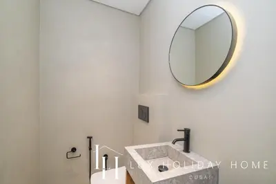 a bathroom with a sink and a mirror at LUX The Premium Marina Sea View Suite in Dubai