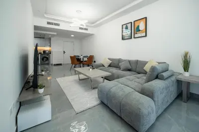 a living room with a couch and a table at Dubai Marina - 1 BHK Unique Apartment in Dubai