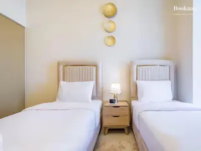 two beds sitting next to each other in a room at Lavish 3BR Apartment with Assistant Room in Habour Gate Tower in Dubai