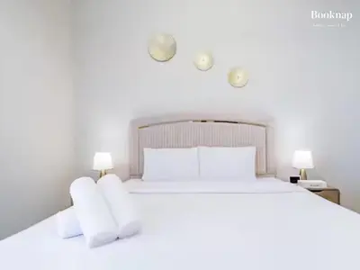a bedroom with a white bed with two lamps at Lavish 3BR Apartment with Assistant Room in Habour Gate Tower in Dubai