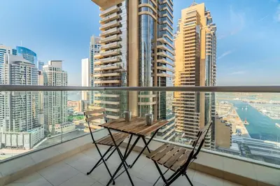 a table and two chairs on a balcony with a view at GuestReady - Mesmerizing Marina views at Iris Blue in Dubai