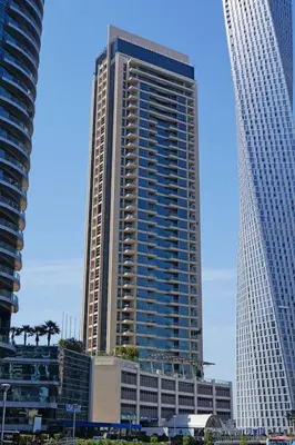 a tall building in the middle of two other buildings at GuestReady - Mesmerizing Marina views at Iris Blue in Dubai