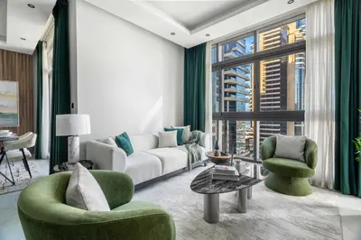 a living room with a couch and two chairs at GuestReady - Mesmerizing Marina views at Iris Blue in Dubai